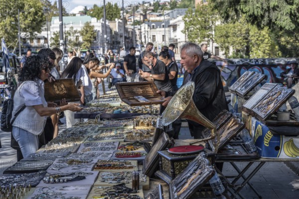 Tbilisi, Georgia. September 12th 2025. Street stall vendors and people shopping at the Dry Bridge Flea Market selling antiques and old Soviet memorabilia in Tbilisi Old Town near the River Kura