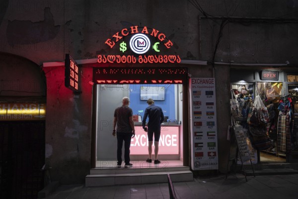 Tbilisi, Georgia. September 5th 2025. Foreign tourists changing money at a Georgian currency exchange office in the Old Town district of Tbilisi, Georgia