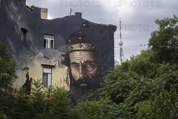 Tbilisi, Georgia. August 27th 2025. A large street art wall mural with the TV telecommunications tower on top of Mtatsminda hill in the background, Tbilisi, capital of Georgia