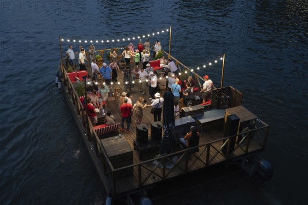 Tbilisi, Georgia. September 5th 2025. Tourists enjoy dancing and drinking on a floating raft type boat on the Kura River also known in Georgia as the Mtkvari River in the Georgian capital, Tbilisi, Georgia