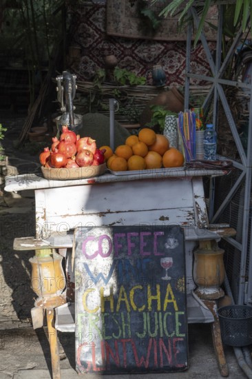 A local street stall selling fresh pomegranate and orange juice in the Old Town district of Tbilisi, Georgia