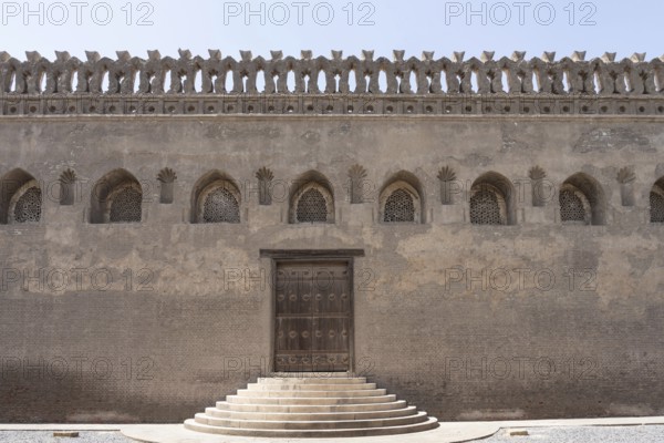 Entrance door and decorative wall of the Tulunid Dynasty Mosque of Ibn Tulun in the Islamic Quarter of the ancient city of Cairo, Egypt