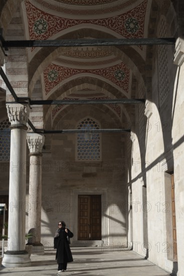 Istanbul, Turkey. January 3rd 2025. Muslim woman inside the ornate courtyard and newly restored Yeni Camii or New Mosque in the Eminonu district of Fatih, Istanbul, Turkey