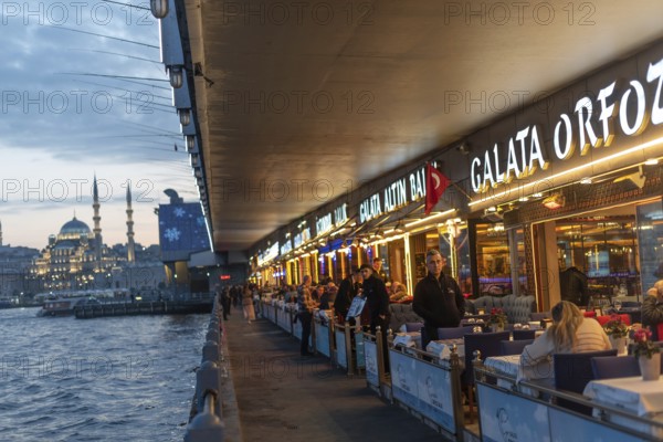Istanbul, Turkey. January 3rd 2025 Fish restaurants at night on the the iconic Galata Bridge at the entrance to the Golden Horn and Bosporus Straight, Istanbul, Turkey