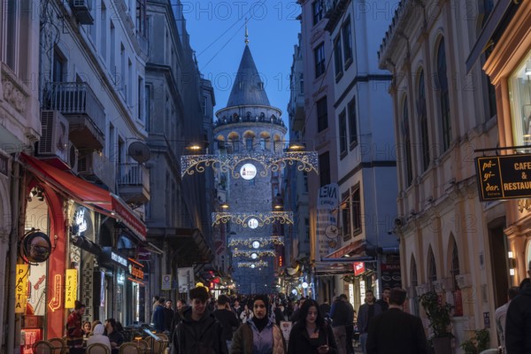 Istanbul, Turkey. January 3rd 2025 Night life at the Galata Tower and museum, a medieval Genoese tower in the Galata part of the Beyoglu a bustling district of shops, cafes and restaurants