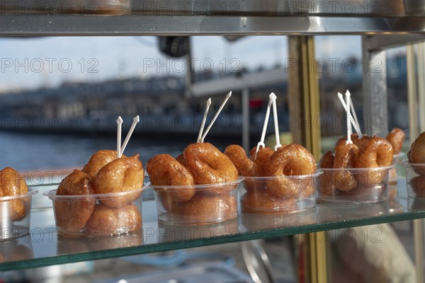 Lokma, traditional deep fried Turkish dessert, street food for sale all over Turkey but the sweet made of syrup and dough is famous in Izmir