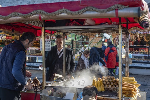Istanbul, Turkey. January 7th 2025 Roasted chestnuts and grilled corn on the cob being served from a typical street stall in a busy shopping bazaar in Istanbul, Turkey