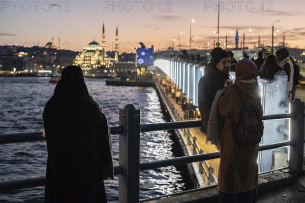 Istanbul, Turkey. January 3rd 2025. Tourists and locals gather at sunset on the iconic Galata Bridge at the confluence of the Bosporus and Golden Horn on the European side of Istanbul, Turkey
