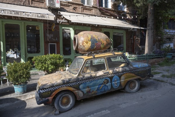 Tbilisi, Georgia. July 29th 2025. An old brightly decorated car being used to promote a wine shop in Tbilisi old town, popular for its cafes, bars and restaurants