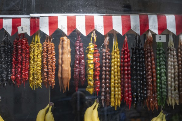 A colorful shop display of Churchkhela, a popular sweet snack made of nuts threaded on string and dipped in grape juice, Tbilisi Old Town, Georgia