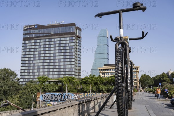 Tbilisi, Georgia. August 5th 2025. Iconic landmark of Big Bike Monument and the Radisson Blu Hotel at Rose Revolution Square, a high end hotel in Tbilisi city center, Georgia