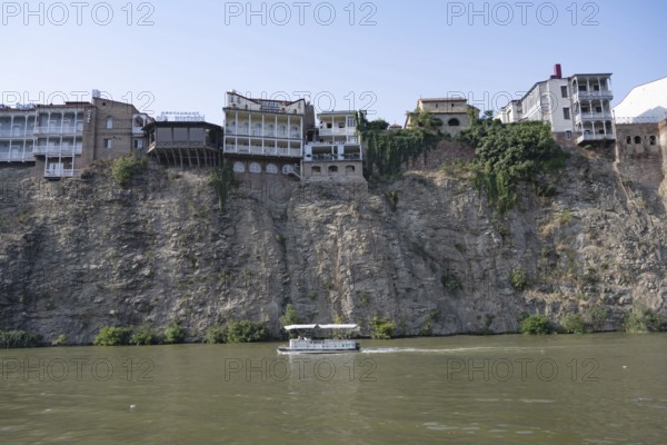 Tbilisi, Georgia. July 29th 2025. Hotels and other building sit precariously on a cliff above the Mtkvari or Kura River in the center of Tbilisi, Georgia