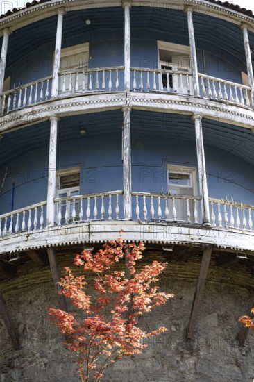 Tbilisi, Georgia. August 5th 2025. An old traditional blue painted Georgian building with a typical wooden balcony, Tbilisi city center, Georgia