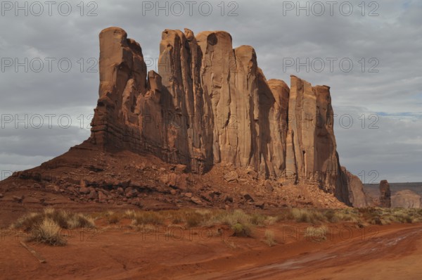 Majestic rocks in bright red rise in a barren desert landscape after a severe thunderstorm, Monument Valley, Navajo Tribal Park, Navajo Nation Reservation, Utah, Arizona, USA