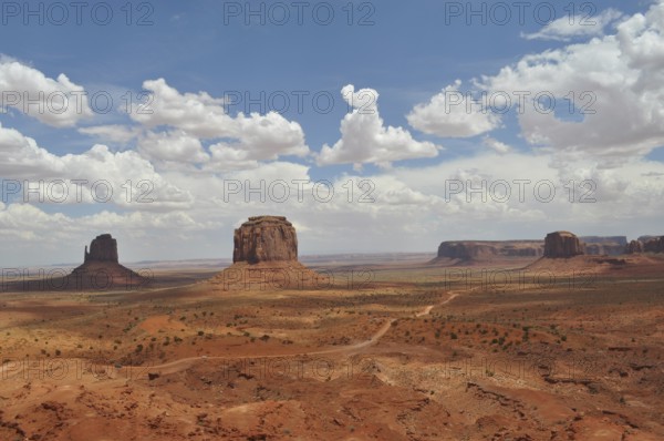 Wide landscape with distinctive rocks and dramatic sky in Monument Valley, Navajo Tribal Park, Navajo Nation Reservation, Utah, Arizona, USA