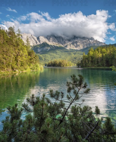 View over Lake Eibsee lake, the Wetterstein Mountains with the Zugspitze in the background, clouds moving across the peaks, Grainau, Garmisch-Partenkirchen, Bavaria, Germany