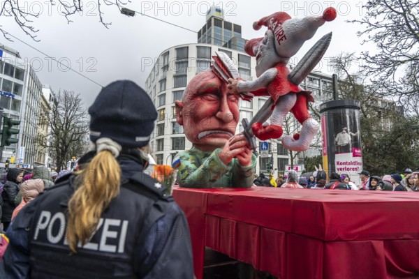 Rose Monday procession in Düsseldorf, theme car by wagon maker Jacques Tilly, Putin impales the symbolic figure of the carnival, Hoppeditz, the satire clown who fights back with the fool's joke, on the subject of court action against Tilly in Russia for his theme cars against Putin and the Ukraine war, North Rhine-Westphalia, Germany