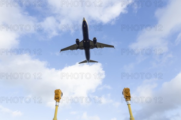 Boeing 737 commercial passenger airliner jet aircraft of Ryanair airways in flight on approach to land over runway lights at London Stansted airport, Essex, England, United Kingdom
