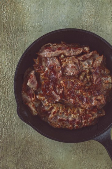 Crispy bacon, in a cast-iron skillet, rustic style, no people