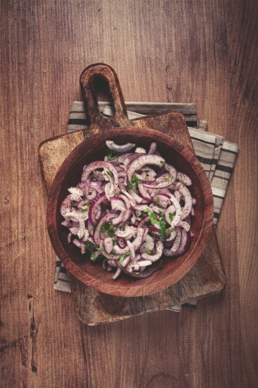 Chopped red onion, with sumac and herbs, in a bowl, pickled Spanish onion, close-up, top view