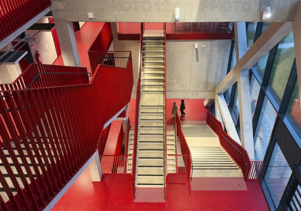 Staircase with signal red color scheme in seminar building H of Bochum University, Ruhr area, North Rhine-Westphalia, Germany