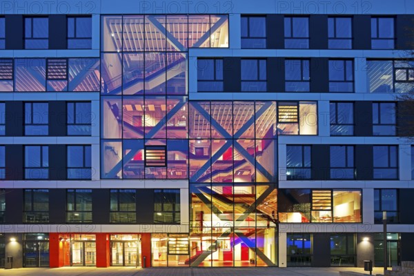 Bochum University seminar building in the evening with an eye-catching staircase with a signal red color scheme, Ruhr area, North Rhine-Westphalia, Germany