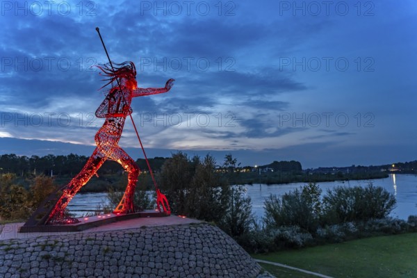 Peaceful Warrior Vreedzame Krijger sculpture on the Maas at dusk, Venlo, the Netherlands