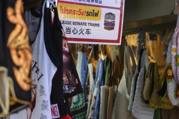Mae Klong, Thailand. March 15th 2025. A sign warning tourists to beware of the train at the Mae Klong Railway market, in Samut Songkhram province of Thailand