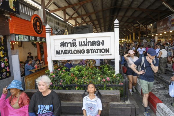 Mae Klong, Thailand. March 15th 2025. Tourists at the entrance to The Maeklong Railway station in Samut Songkhram province of Thailand