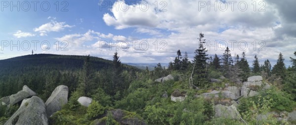 Panoramic view from Nusshardt over a wooded landscape with rocks and cloudy sky in the background, Franconian mountain trail, hiking in the Fichtelgebirge nature park Park
