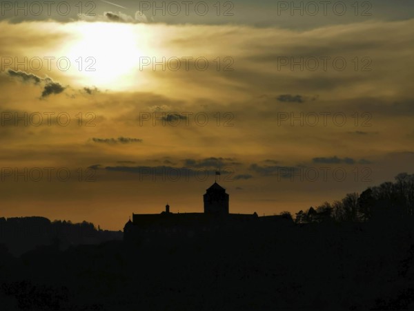 Silhouette of Rosenberg Fortress in Kronach in front of dramatic sunset sky, Frankenwald nature park Park