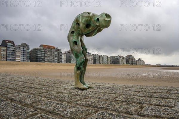 Art on the North Sea beach, in Knokke-Heist, Tomorrow Man by Cathérine François, is washed over by the sea at high tide, many permanent works of art in public spaces are spread around the city, here on the beach on Zeedijk-Knokke, beach promenade, dreary winter day, Belgium