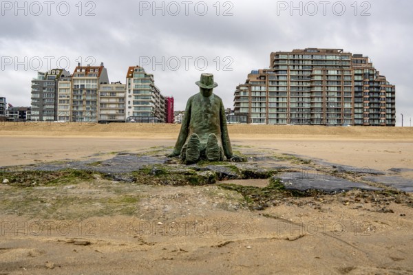 Art on the North Sea beach, in Knokke-Heist, La Mer, ce grand sculpteur, or The Sea, the Great Sculptor, by Jean-Michel Folon, is washed over by the sea at high tide, many permanent works of art in public spaces are spread around the city, here on the beach on the Zeedijk-Knokke, beach promenade, dreary winter day, Belgium