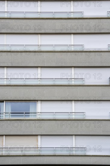 Facades of residential buildings on Zeedijk-Knokke, beach promenade in Knokke-Heist, largely uninhabited in winter, on the North Sea beach, dreary winter day, mostly apartment buildings with rental or condominiums, high-rise buildings on the street, Belgium