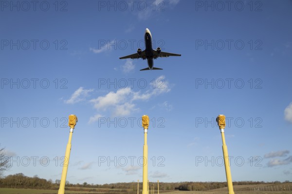 Boeing 737 commercial passenger airliner jet aircraft of Ryanair airways in flight on approach to land over runway lights at London Stansted airport, Essex, England, United Kingdom