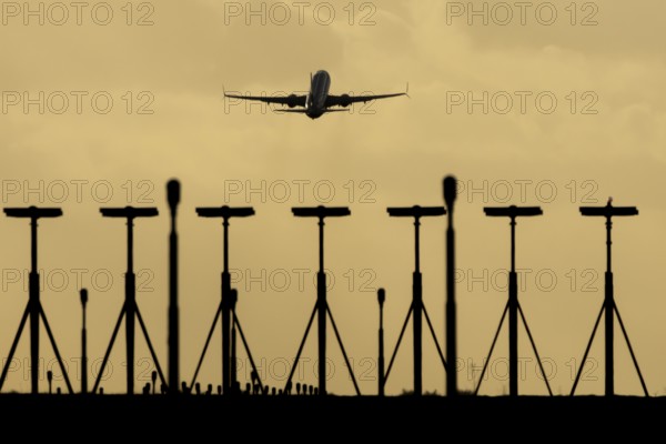 Commercial passenger airliner jet aircraft taking off in flight at sunset at London Stansted airport, Essex, England, United Kingdom