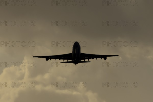 Boeing 747-400 jumbo jet LX-TCV commercial aircraft of Cargolux cargo taking off in flight silhouette at sunset at London Stansted airport, Essex, England, United Kingdom