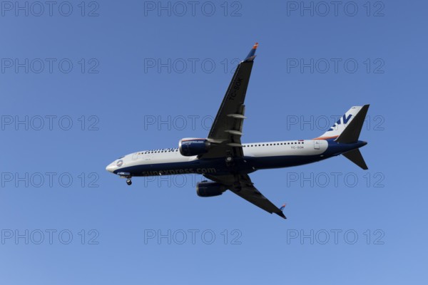 Boeing 737 commercial passenger airliner jet aircraft of SunExpress airways in flight on approach to land at London Stansted airport, Essex, England, United Kingdom