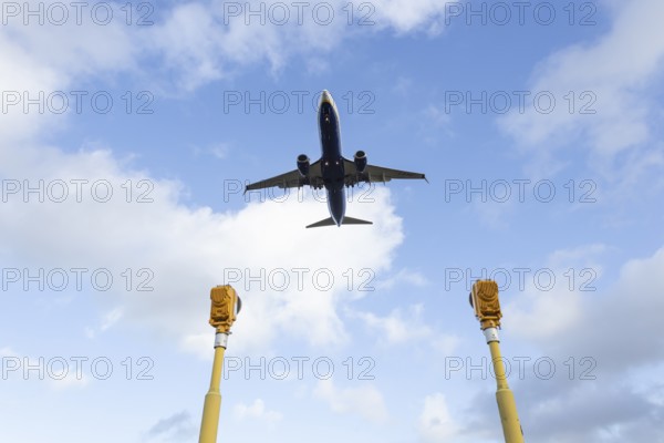 Boeing 737 commercial passenger airliner jet aircraft of Ryanair airways in flight on approach to land over runway lights at London Stansted airport, Essex, England, United Kingdom
