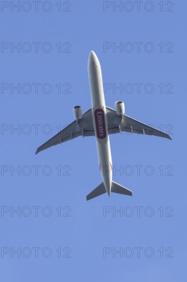 Boeing 777 commercial passenger airliner jet aircraft of Emirates airways in flight at London Stansted airport, Essex, England, United Kingdom