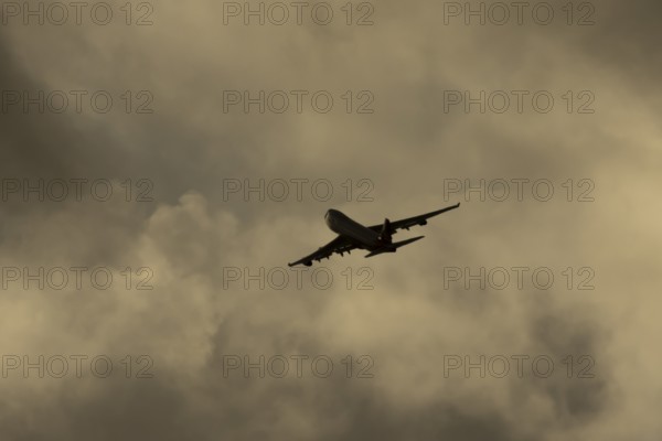 Boeing 747-400 jumbo jet LX-TCV commercial aircraft of Cargolux cargo in flight silhouette at sunset at London Stansted airport, Essex, England, United Kingdom