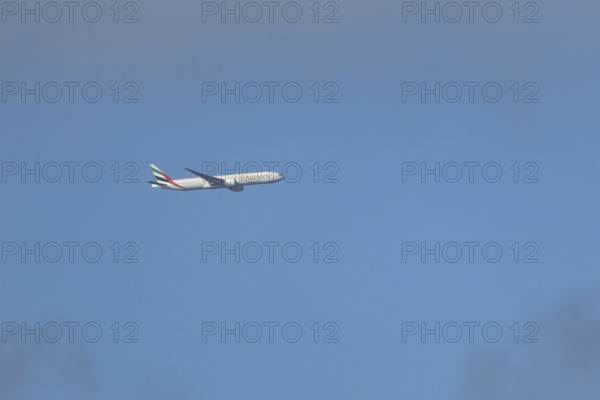Boeing 777 commercial passenger airliner jet aircraft of Emirates airways in flight at London Stansted airport, Essex, England, United Kingdom