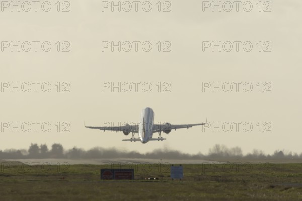 Airbus commercial passenger airliner jet aircraft taking off in flight at London Stansted airport, Essex, England, United Kingdom