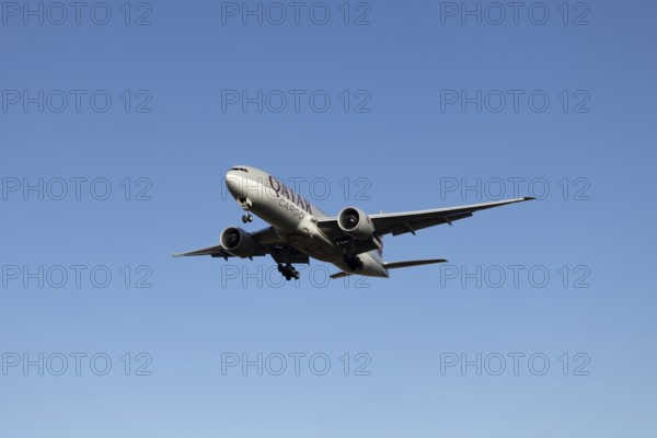 Boeing 777 commercial jet aircraft of Qatar cargo in flight on approach to land at London Stansted airport, Essex, England, United Kingdom