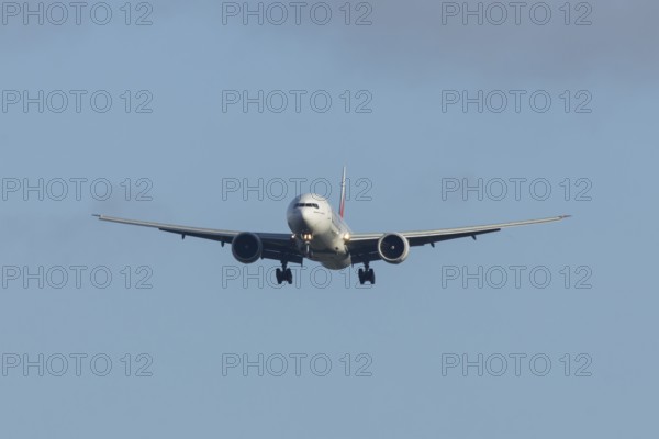 Boeing 777 commercial passenger airliner jet aircraft of Emirates airways in flight on approach to Stansted airport, Essex, England, United Kingdom