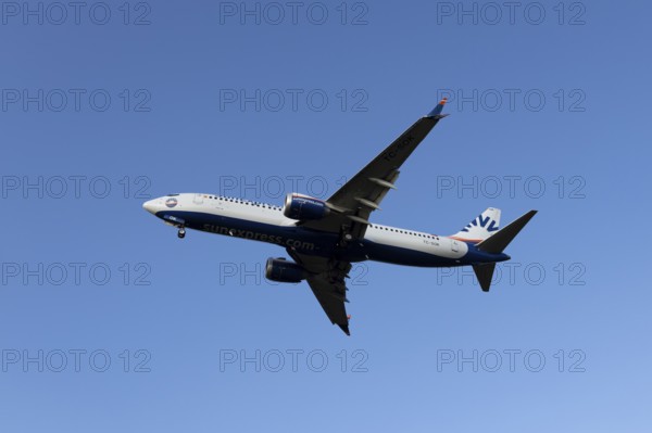 Boeing 737 commercial passenger airliner jet aircraft of SunExpress airways in flight on approach to land at London Stansted airport, Essex, England, United Kingdom