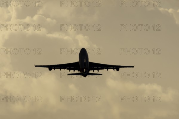 Boeing 747-400 jumbo jet LX-TCV commercial aircraft of Cargolux cargo taking off in flight silhouette at sunset at London Stansted airport, Essex, England, United Kingdom
