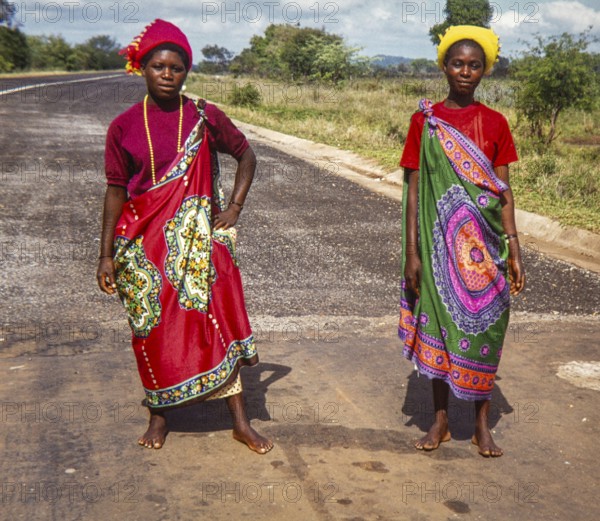 Two women in vibrant traditional Swazi or Zulu attire, showcasing the rich cultural heritage and colorful textiles of South Africa, Africa 1979