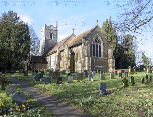 Village parish church of Saint Mary, Martlesham, Suffolk, England, UK and its rural churchyard with gravestones
