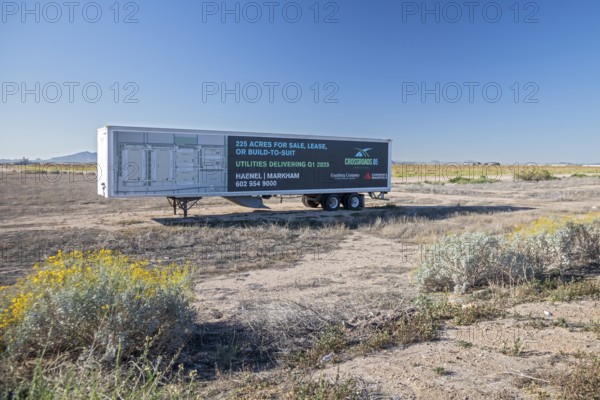 Buckeye, Arizona - An advertisement on a parked semi-trailer offers land for sale for housing development in the Arizona desert. Such developments have been growing quickly in the distant Phoenix suburbs, but a limiting problem is water availability